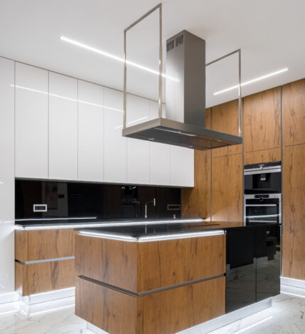 Elegant kitchen with marble floor, wooden details and led lighting turned on